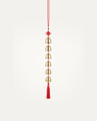 Brass Bell Hanging Charm, six brass bells on a red cord with tassel, studio photo