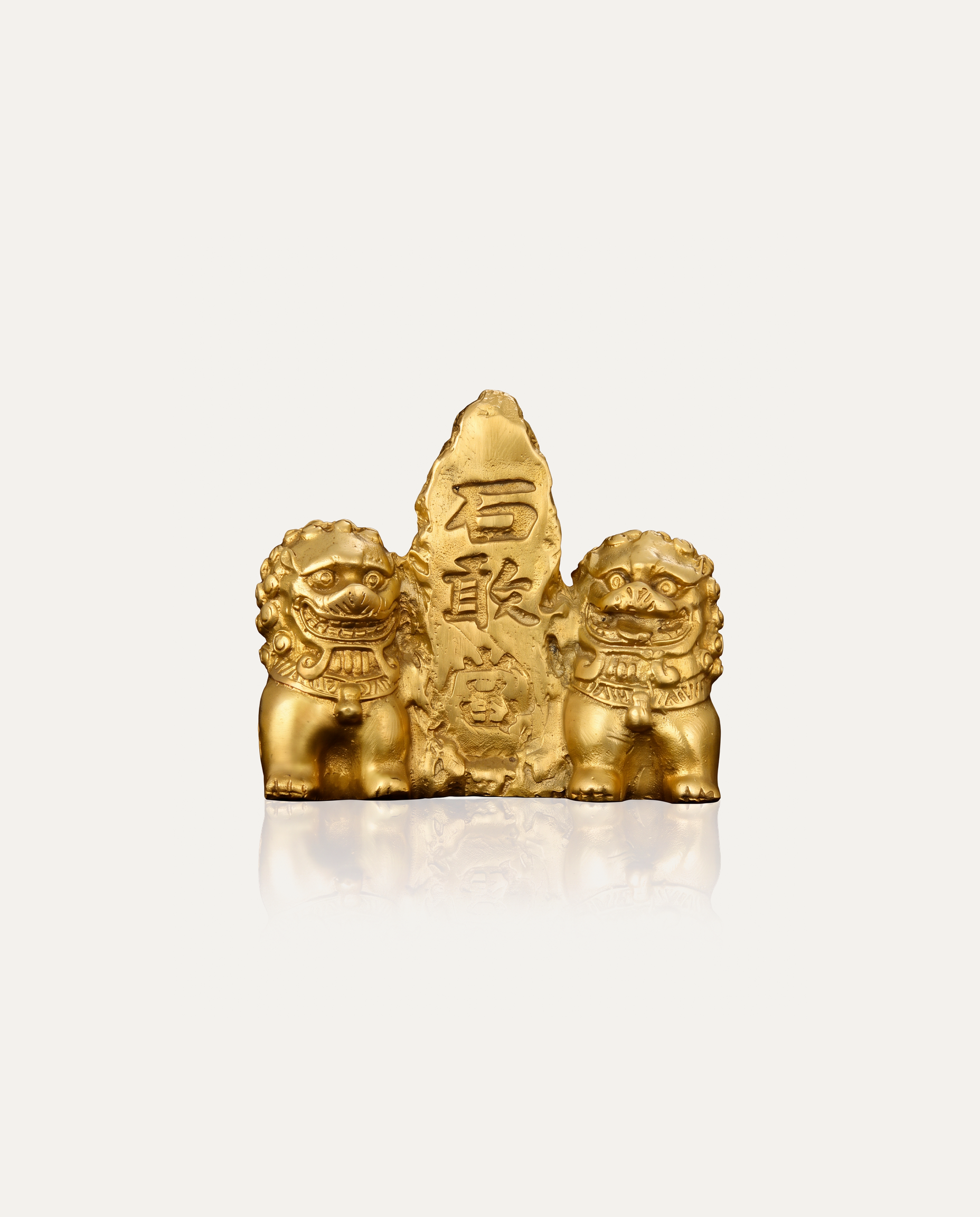 Brass Shi Gan Dang tablet flanked by twin lions, studio photo