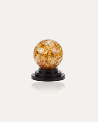 Gold Leaf Feng Shui Ball on black wooden stand, studio photo