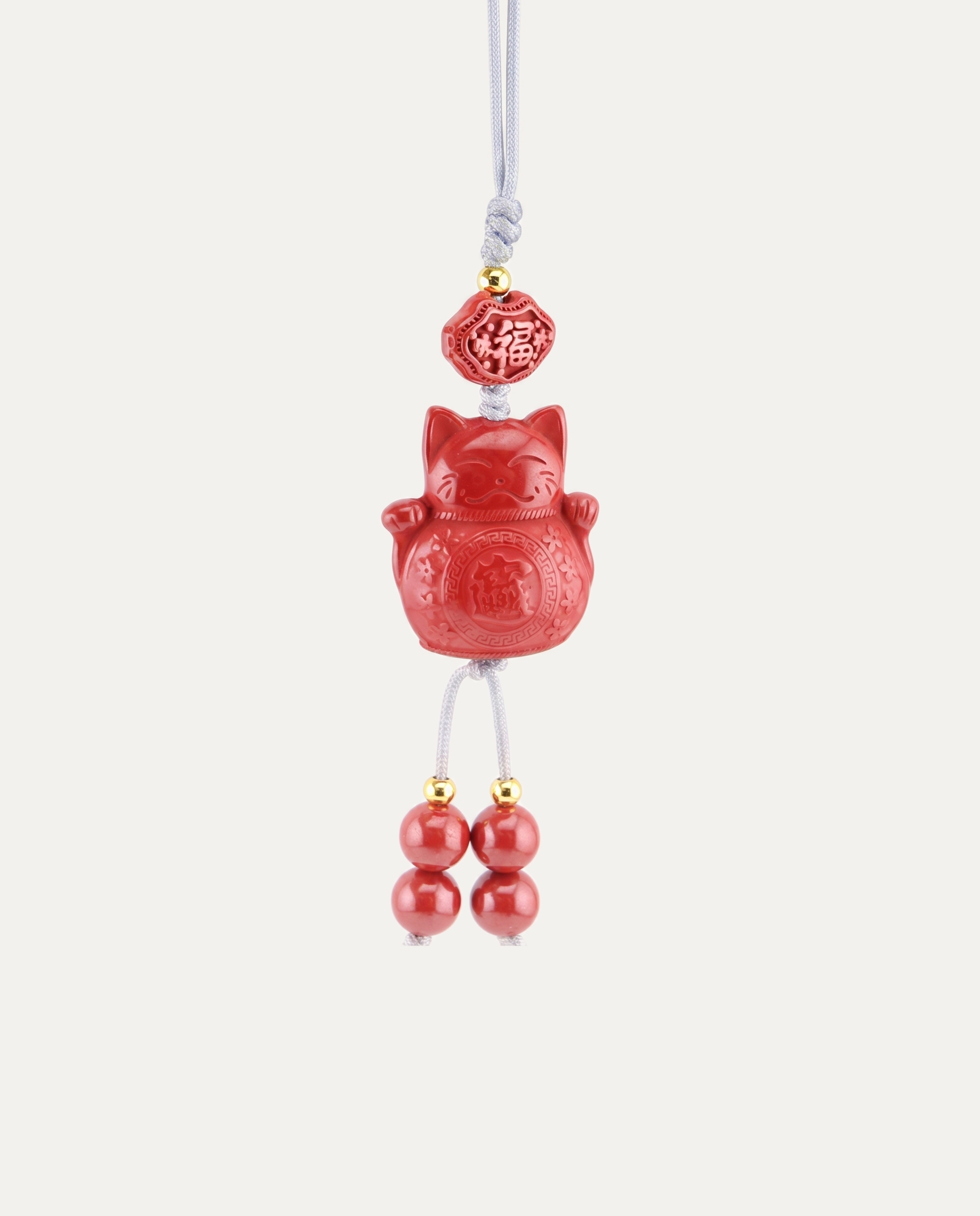 Lucky Cat Cinnabar Hanging Charm, studio photo