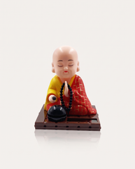 Solar Nodding Monk kneeling with mala on solar base
