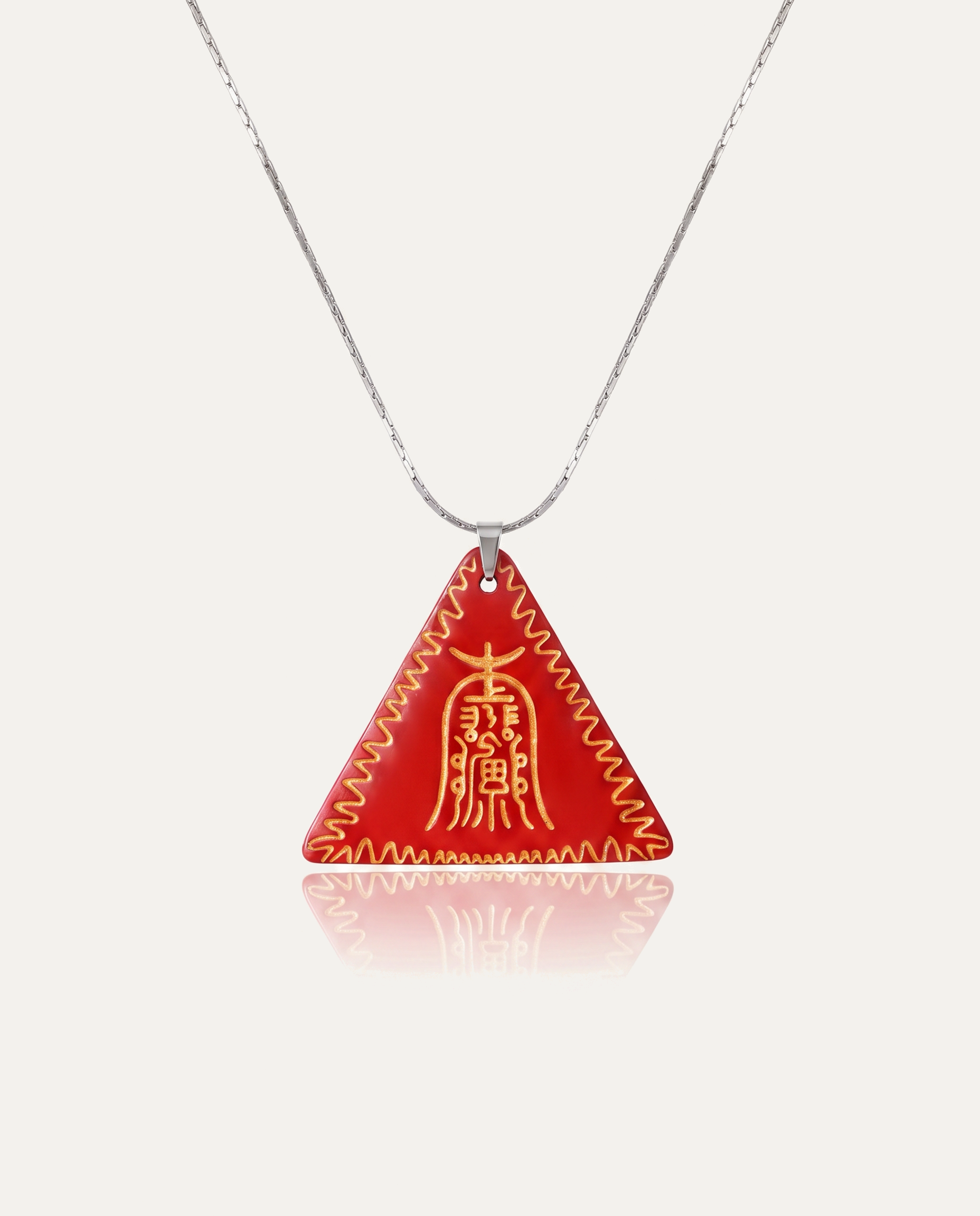 Gold Amitabha Triangle Cinnabar Pendant on silver chain, ivory background