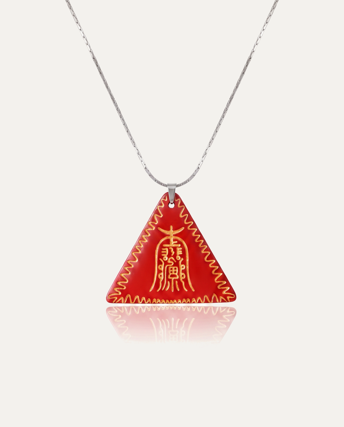 Gold Amitabha Triangle Cinnabar Pendant on silver chain, ivory background