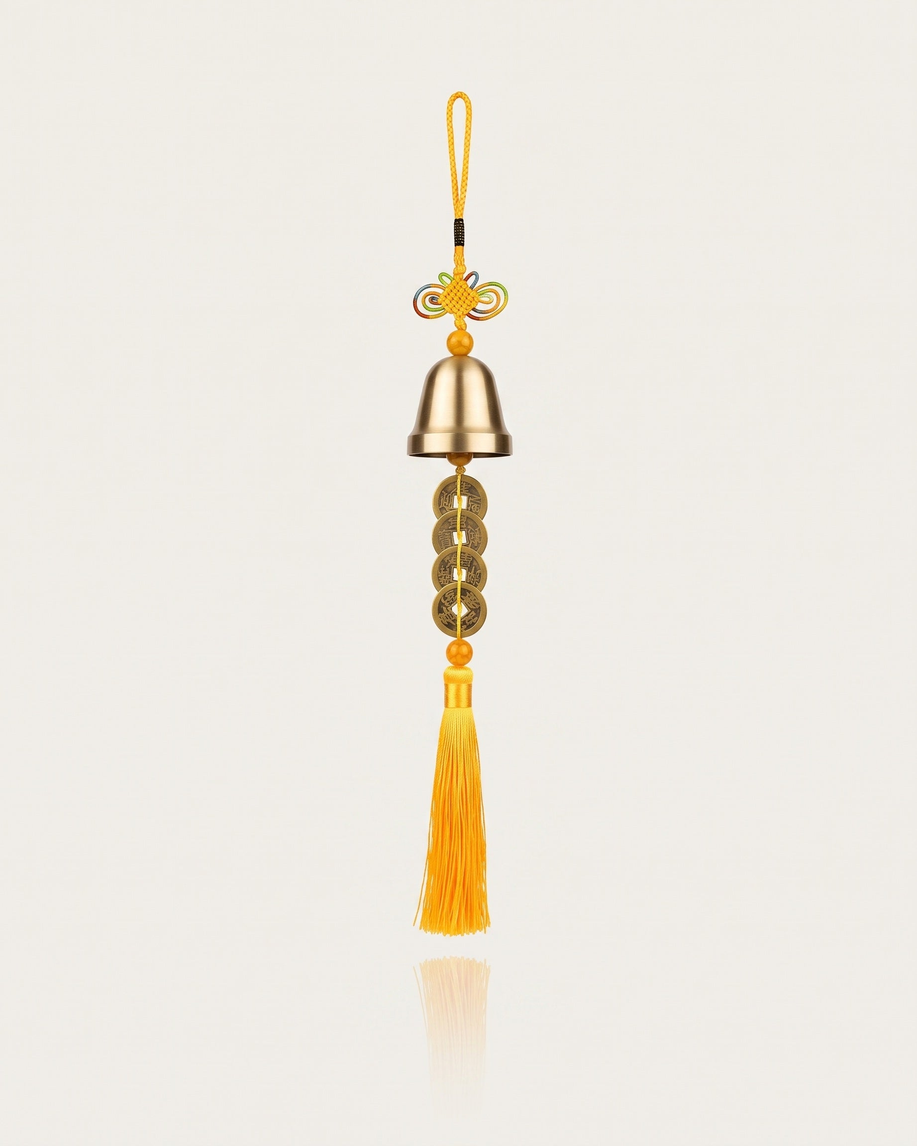 Brass bell with five emperor coins, yellow tassel