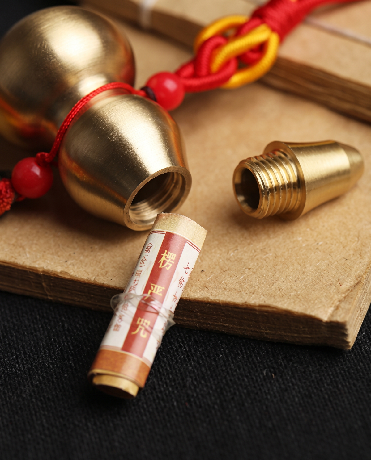 Brass hulu open, with the rolled mantra inside