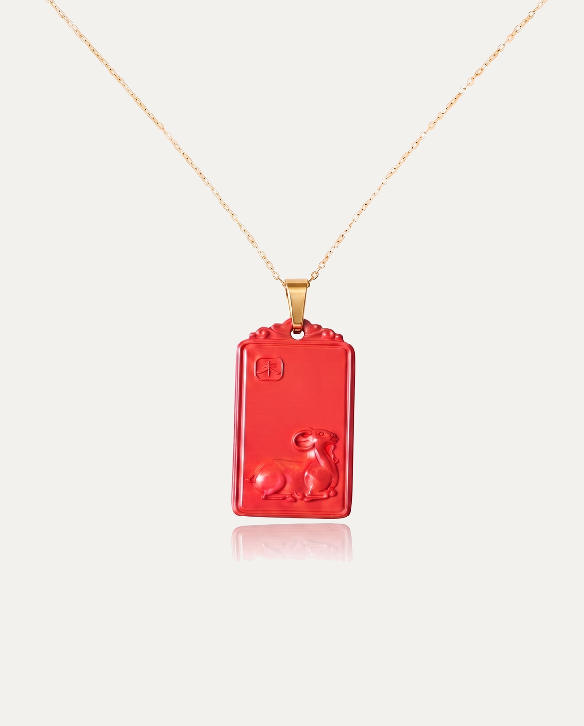 Goat zodiac cinnabar pendant necklace gold chain on ivory background