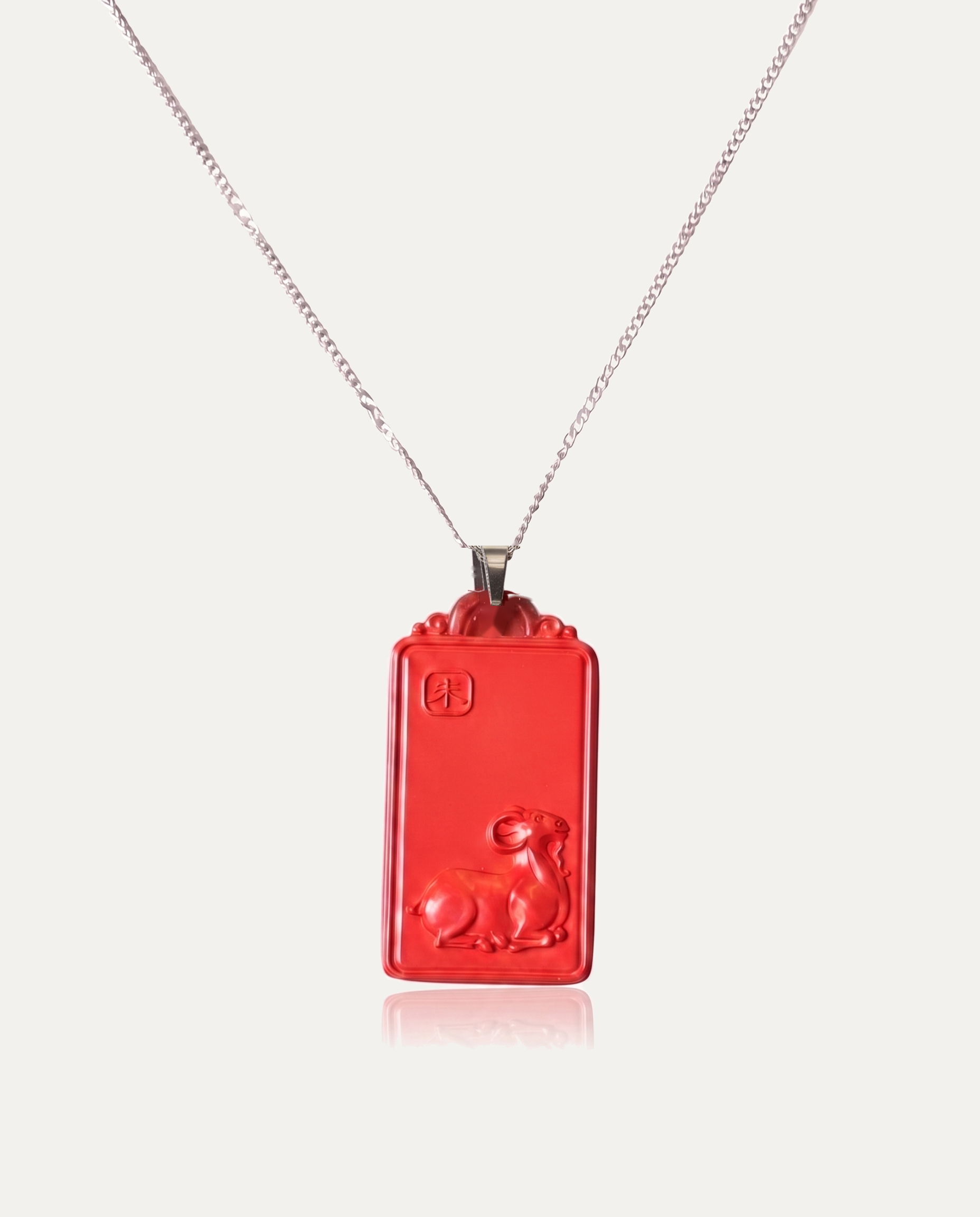 Goat zodiac cinnabar pendant necklace silver chain on ivory background