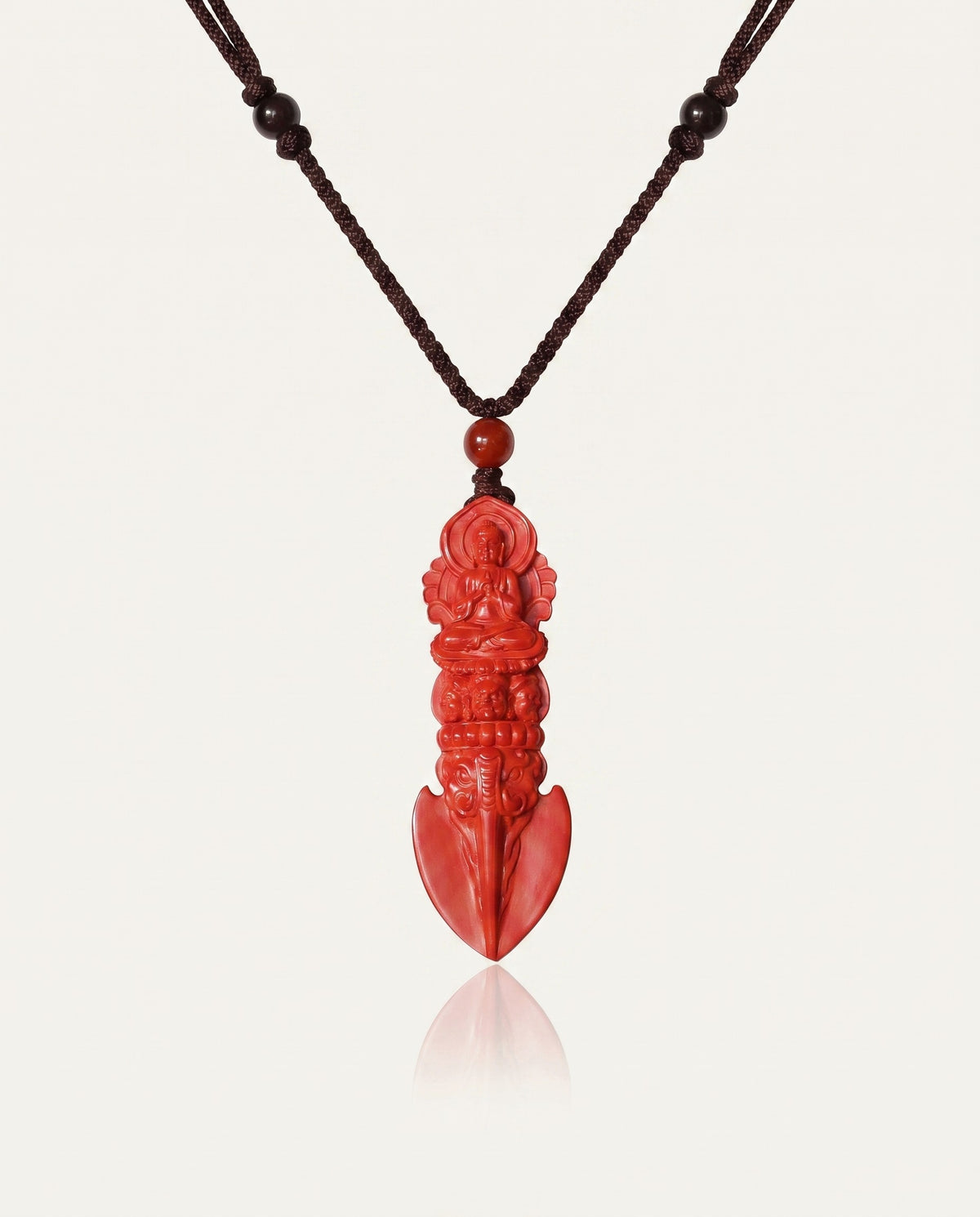 Guan Yin Phurba cinnabar necklace on ivory studio background