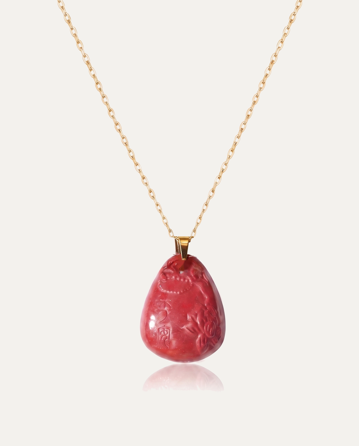 Heart sutra teardrop cinnabar pendant necklace gold chain on ivory background