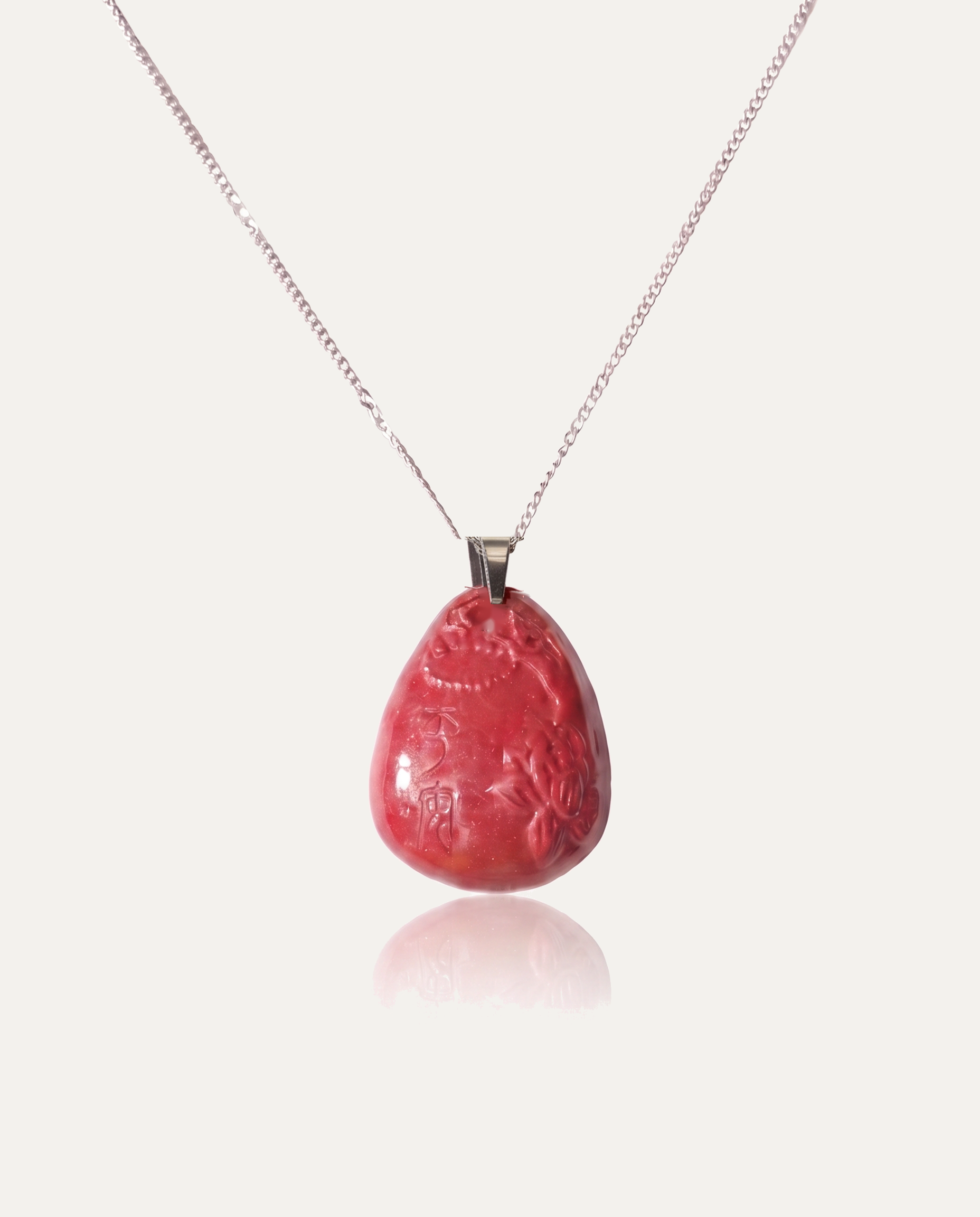 Heart sutra teardrop cinnabar pendant necklace silver chain on ivory background