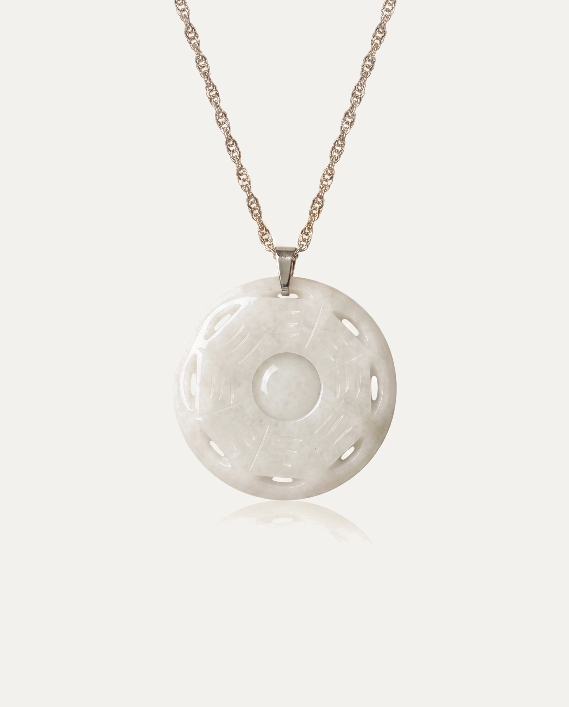 Jade Bagua Necklace with silver chain on ivory background