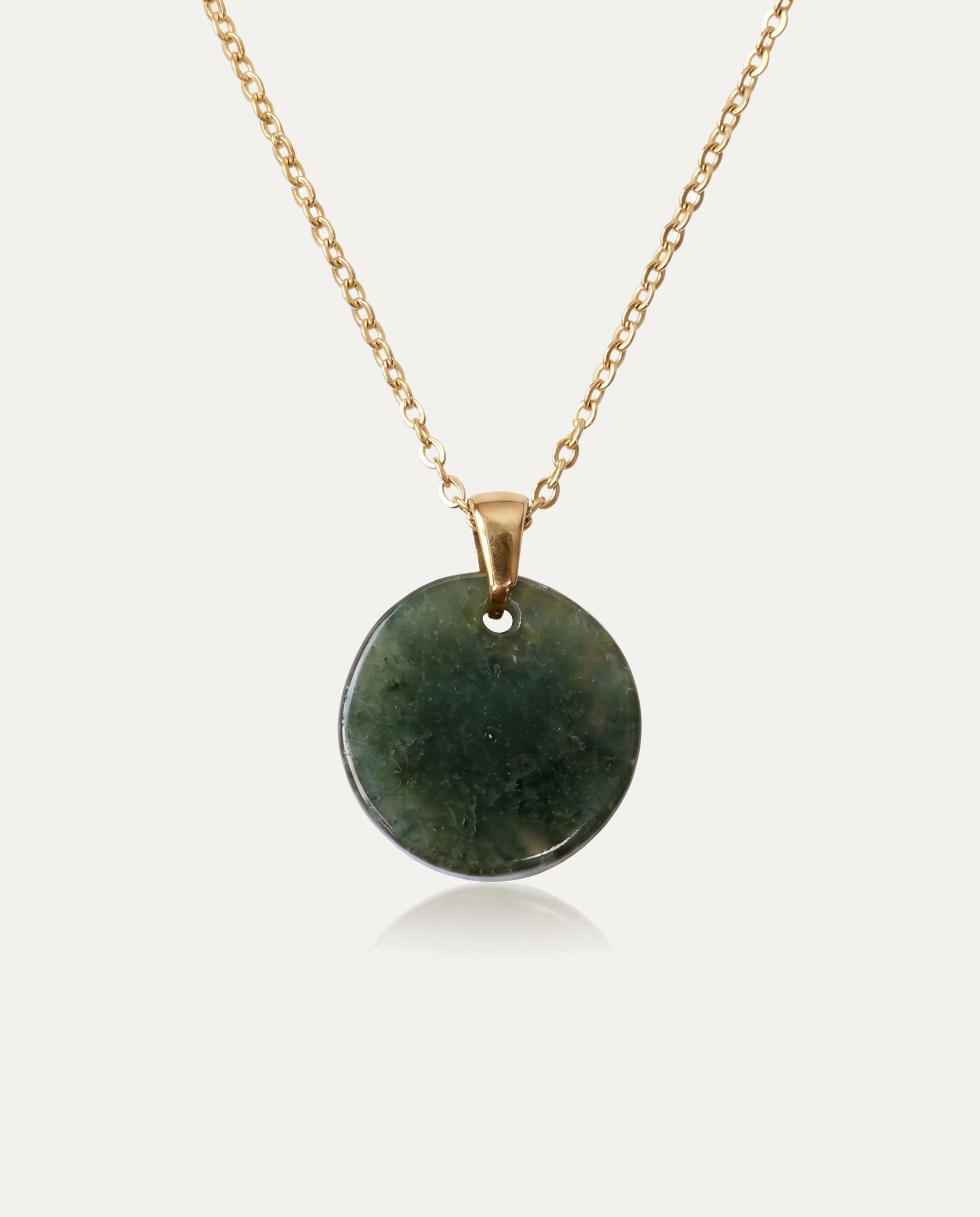 Large Jade Circle Necklace with gold chain on ivory background