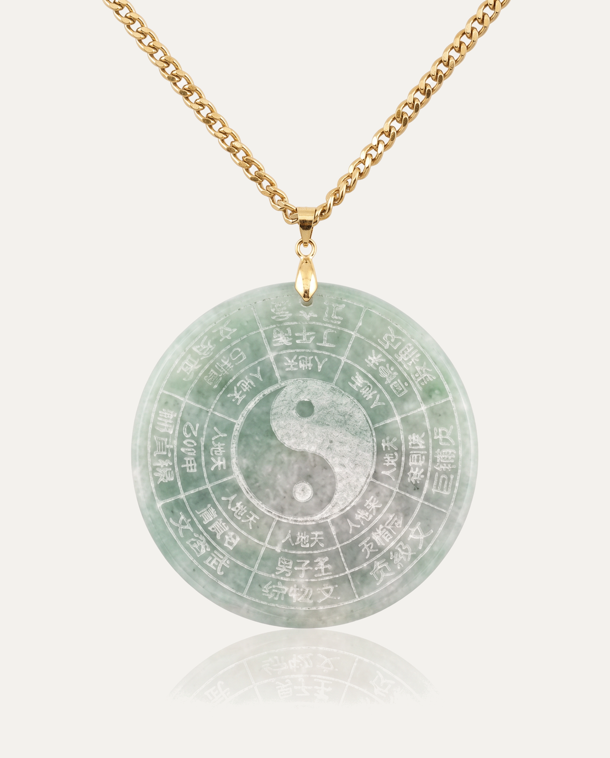 Jade Yin Yang Bagua Necklace with gold chain on ivory background