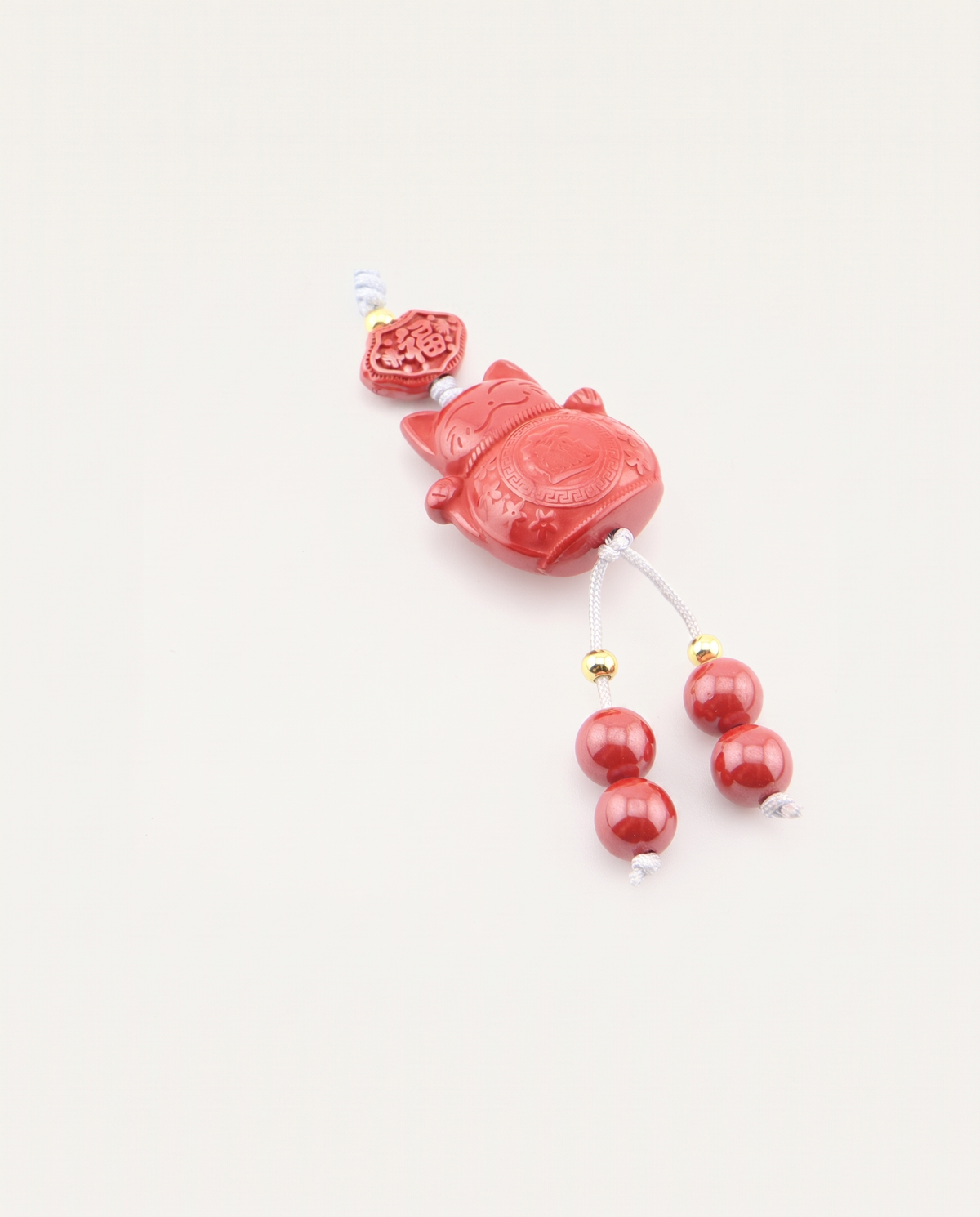 Lucky Cat Cinnabar Hanging Charm, studio photo