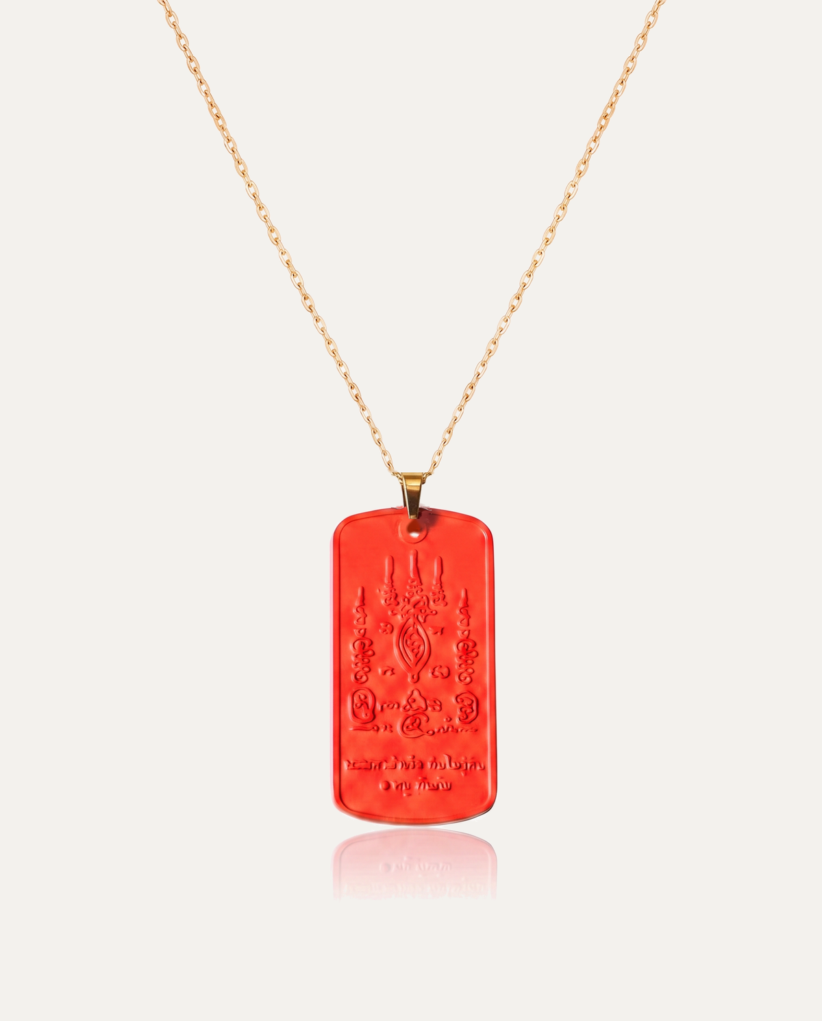 Mantra protection amulet cinnabar necklace gold chain on ivory background