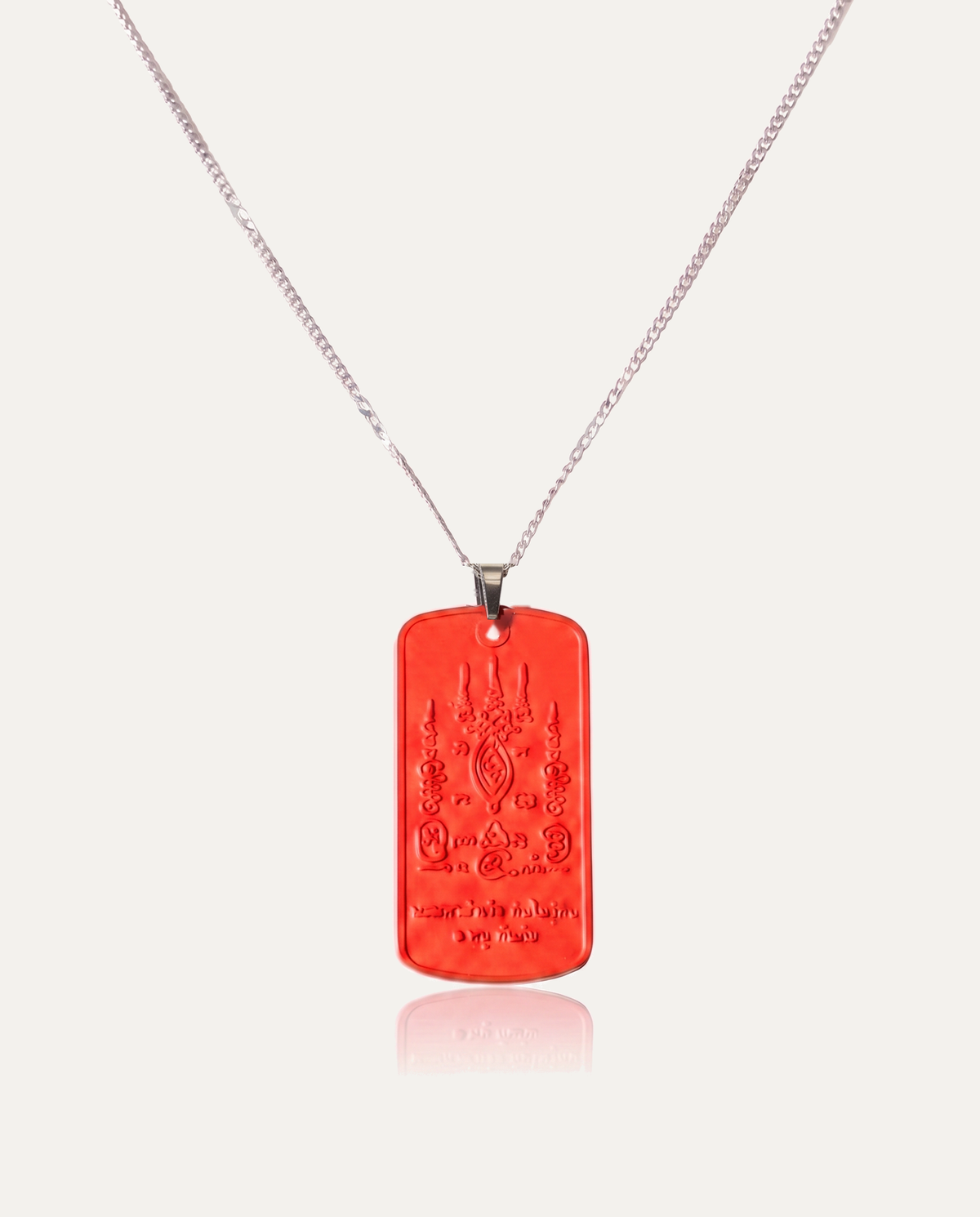 Mantra protection amulet cinnabar necklace silver chain on ivory background