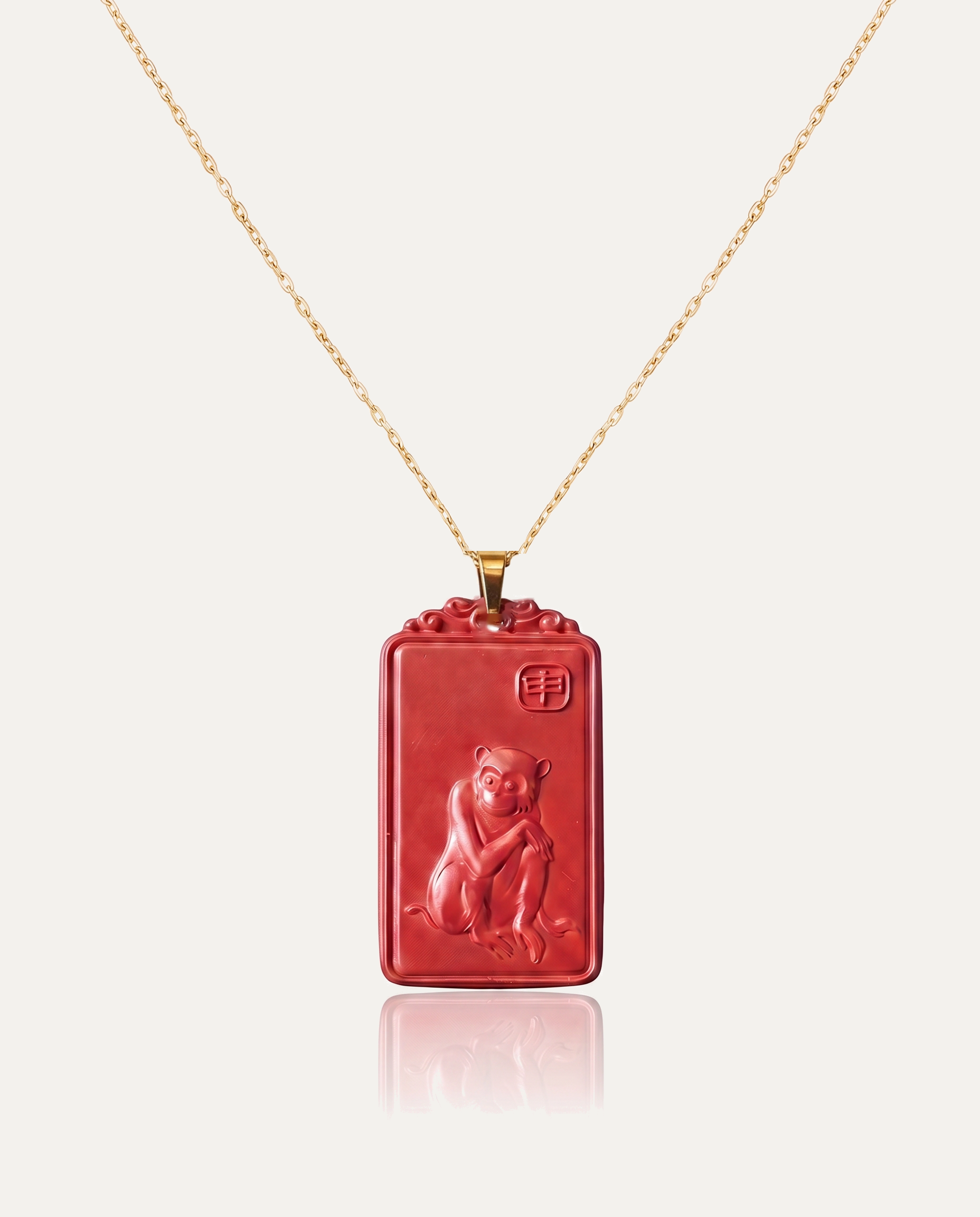 Monkey zodiac cinnabar pendant necklace gold chain on ivory background