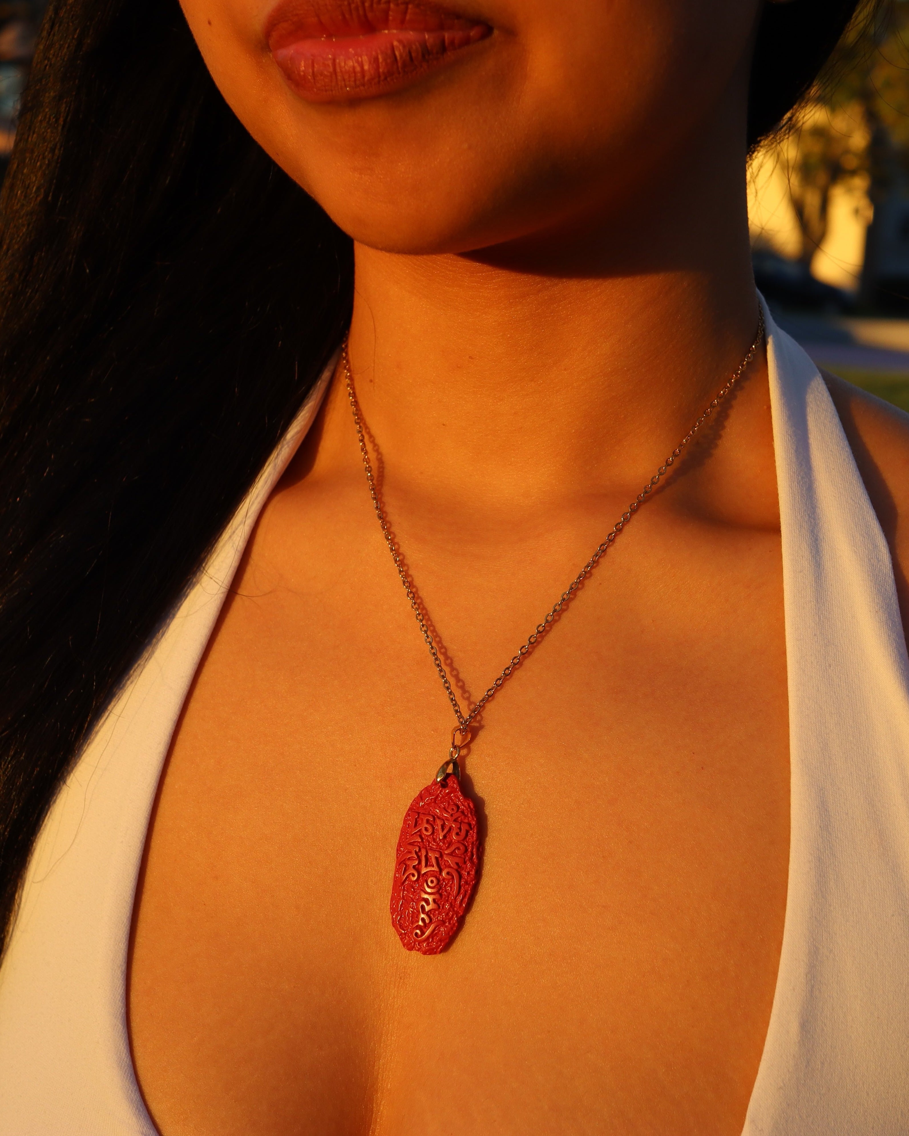 Six Character Mantra cinnabar pendant necklace worn