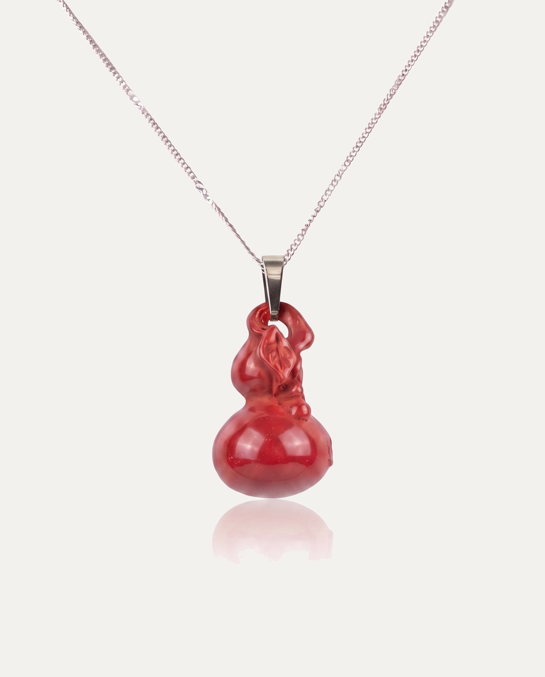 Smooth hulu cinnabar pendant necklace silver chain on ivory background