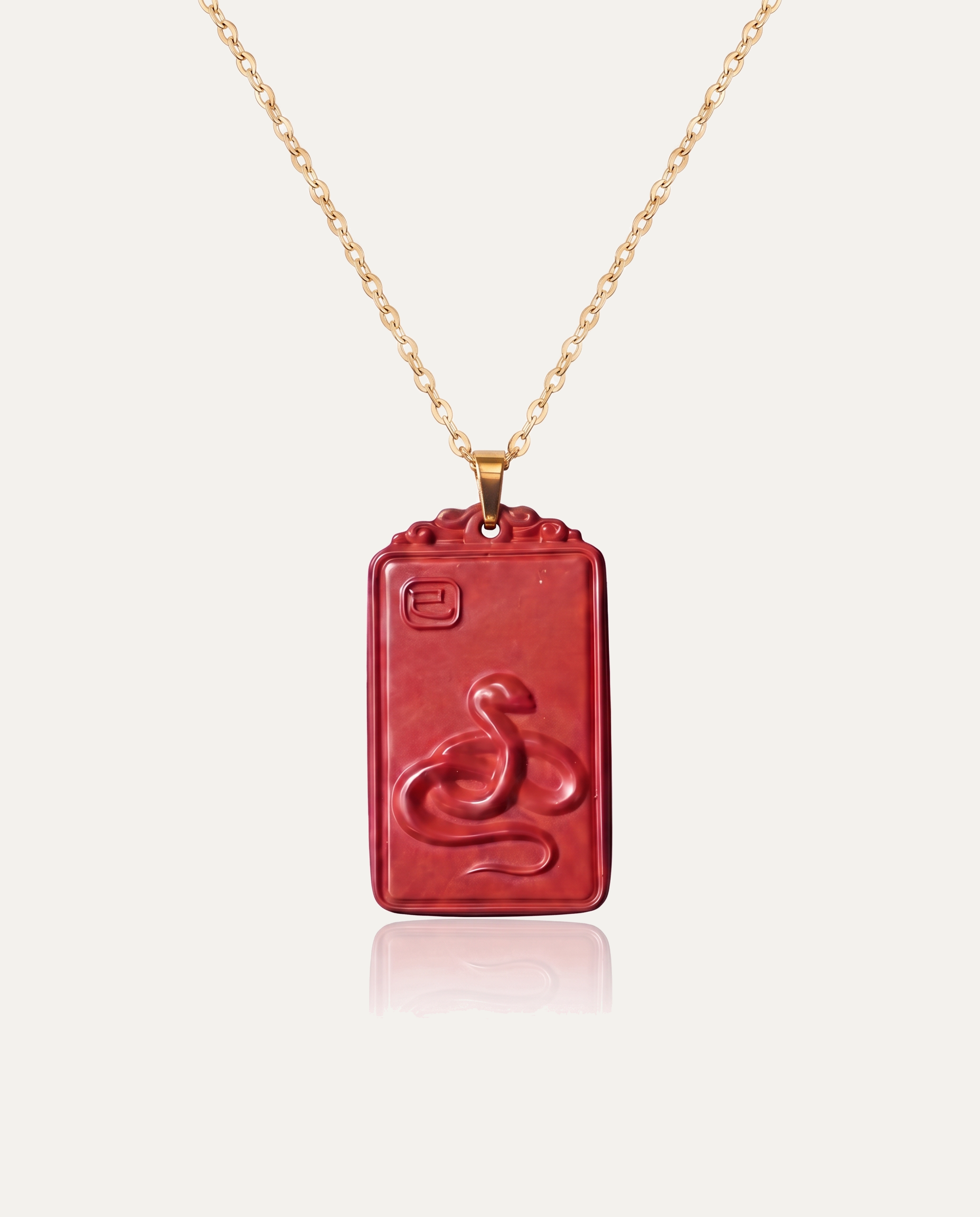 Snake zodiac cinnabar pendant necklace gold chain on ivory background