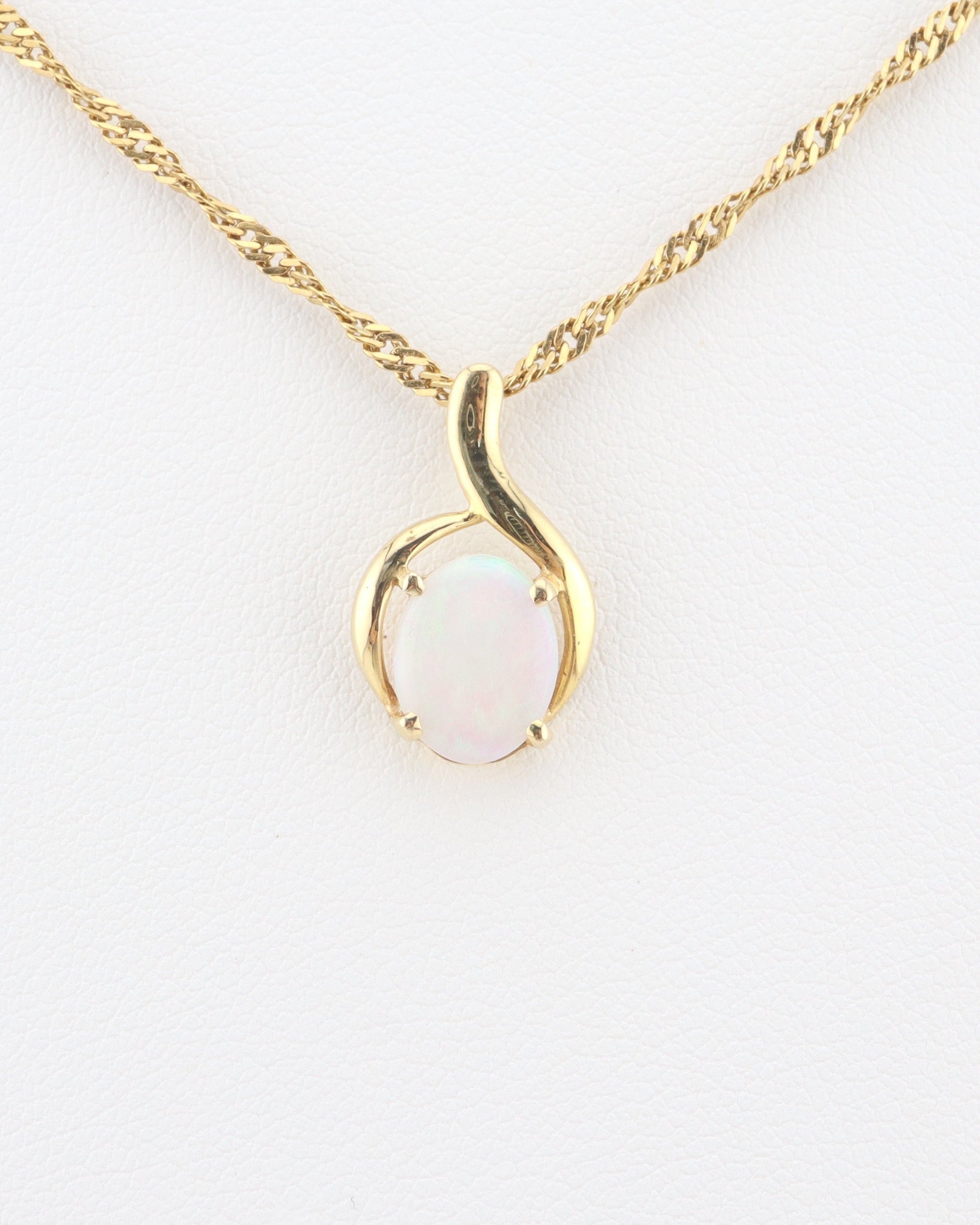 Handmade Australian solid Coober Pedy opal pendant necklace in 18k gold, centered studio shot