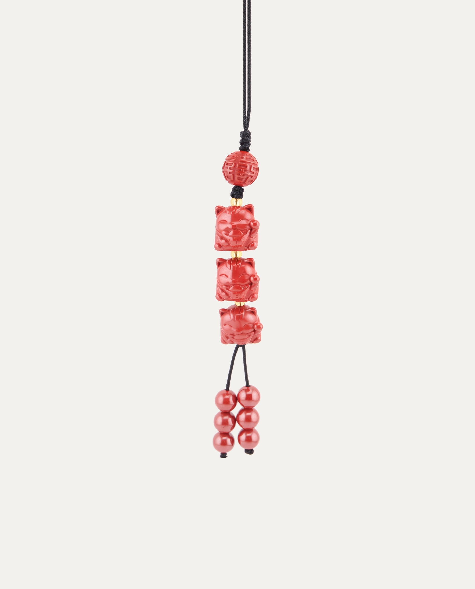 Three Lucky Cats Cinnabar Hanging Charm, studio photo