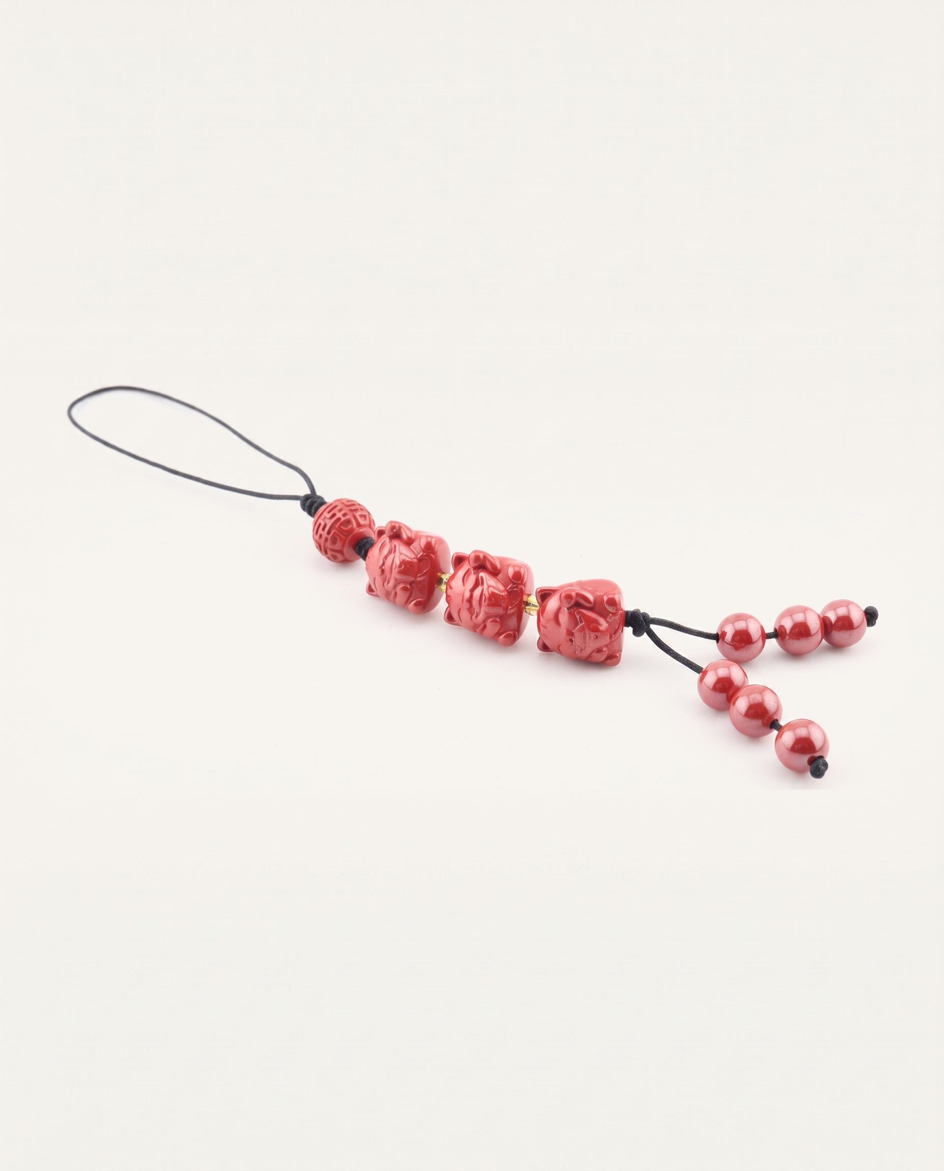 Three Lucky Cats Cinnabar Hanging Charm, studio photo