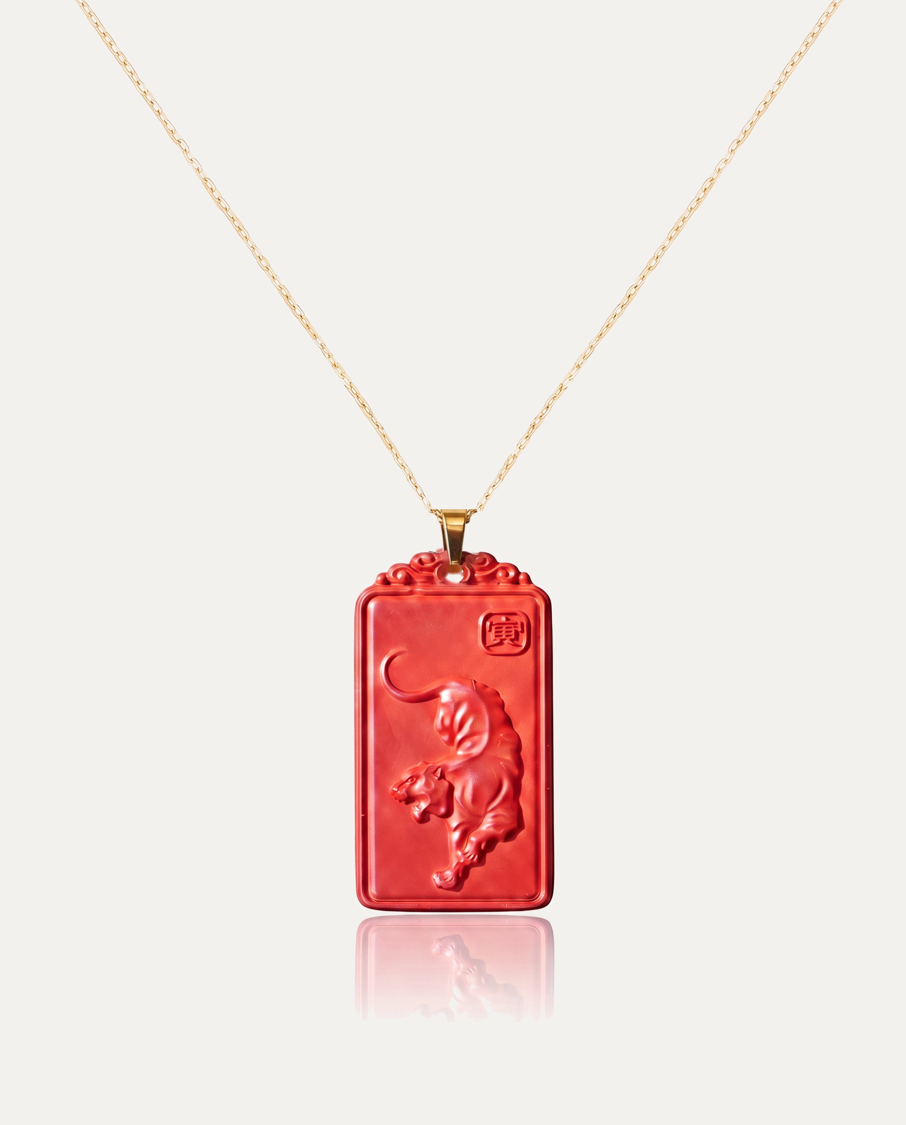 Tiger zodiac cinnabar pendant necklace gold chain on ivory background