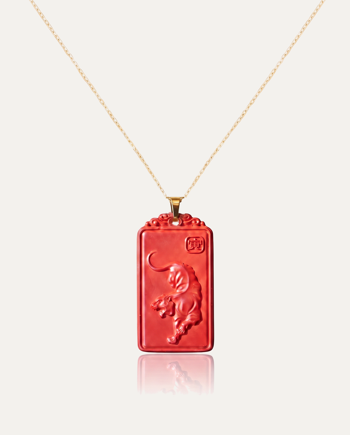 Tiger zodiac cinnabar pendant necklace gold chain on ivory background