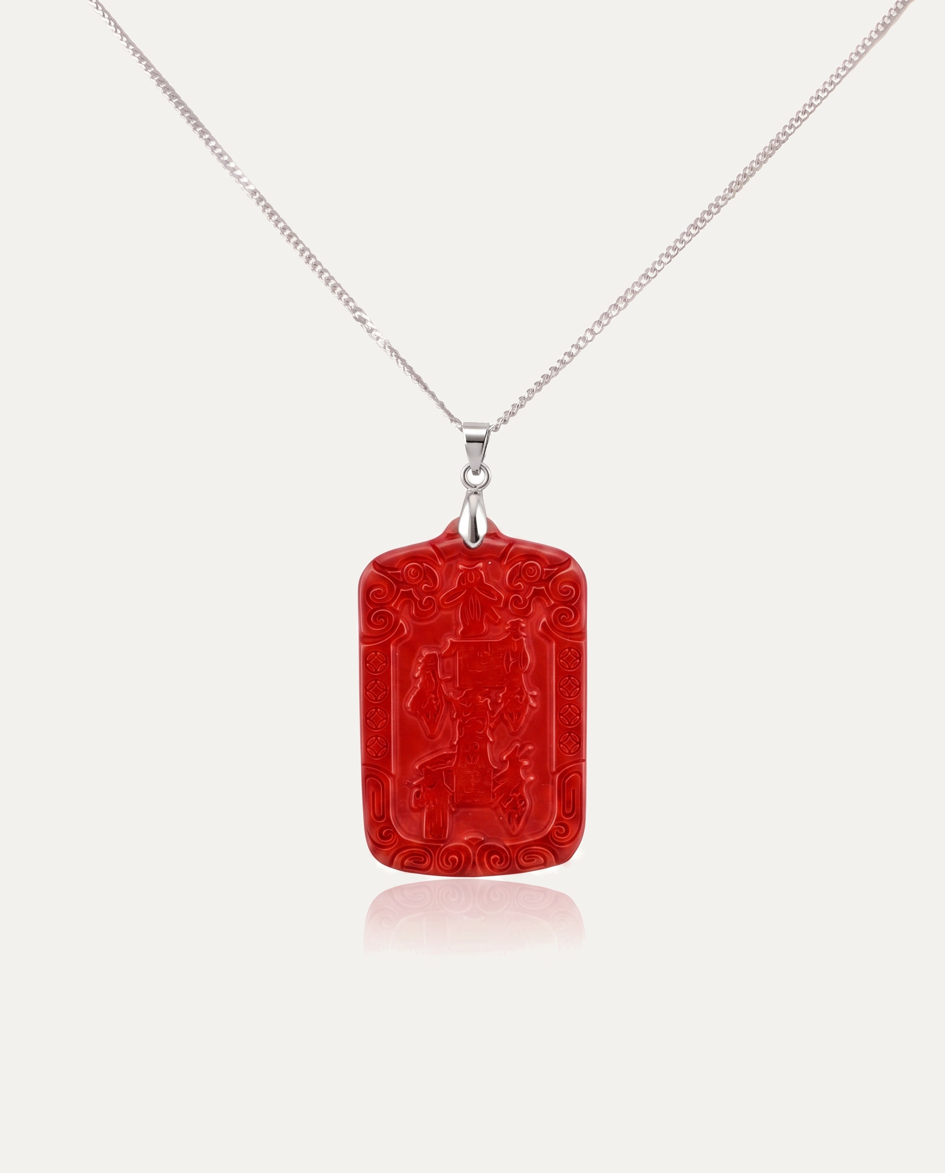 Wealth Talisman Cinnabar Pendant on silver chain, ivory background