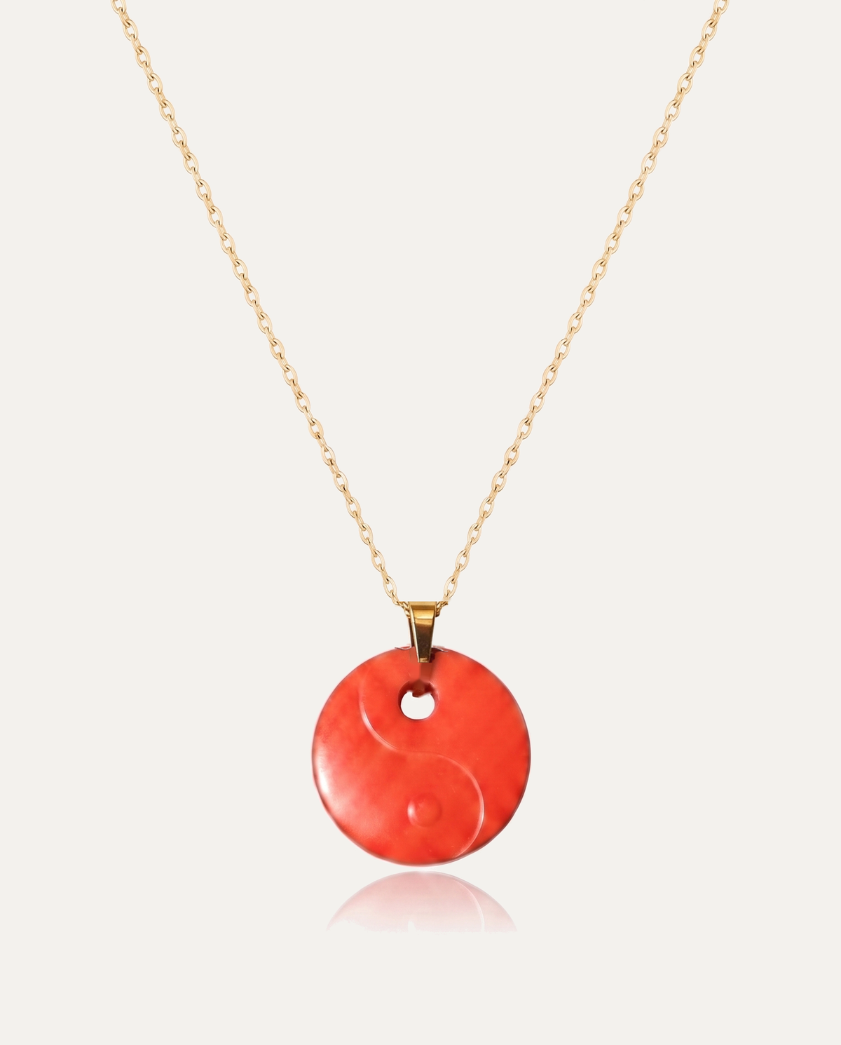 Yin yang cinnabar pendant necklace gold chain on ivory background