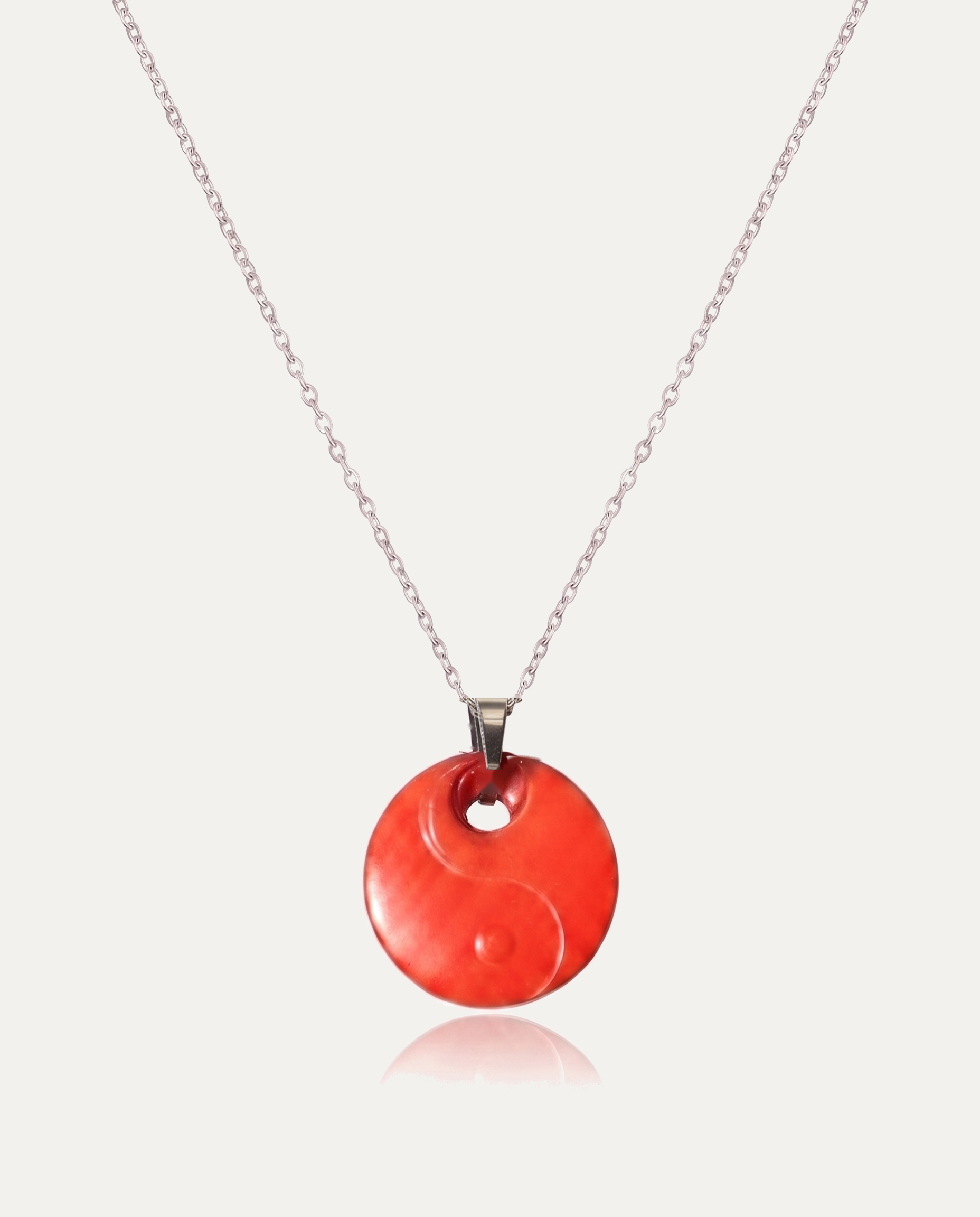 Yin yang cinnabar pendant necklace silver chain on ivory background