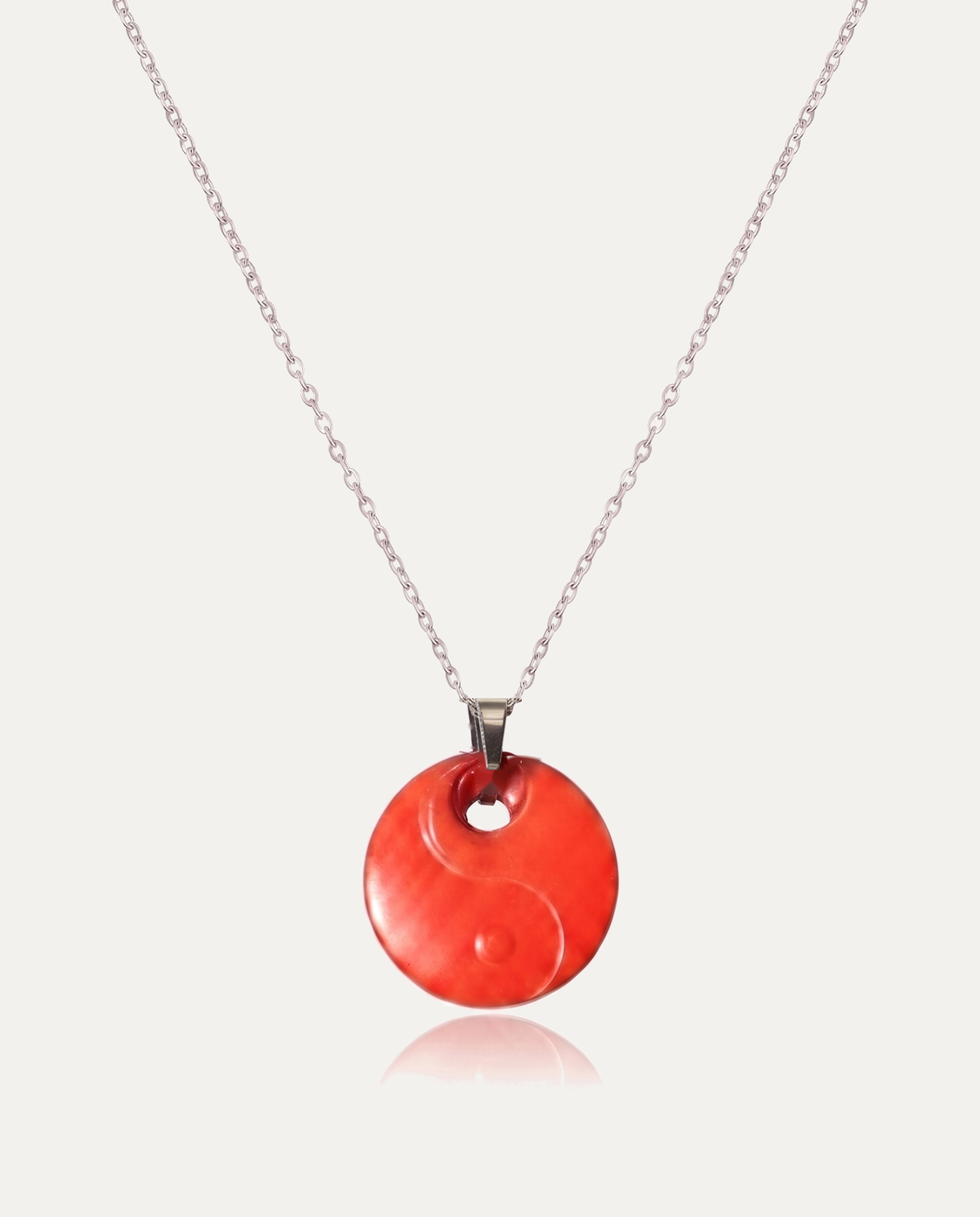 Yin yang cinnabar pendant necklace silver chain on ivory background