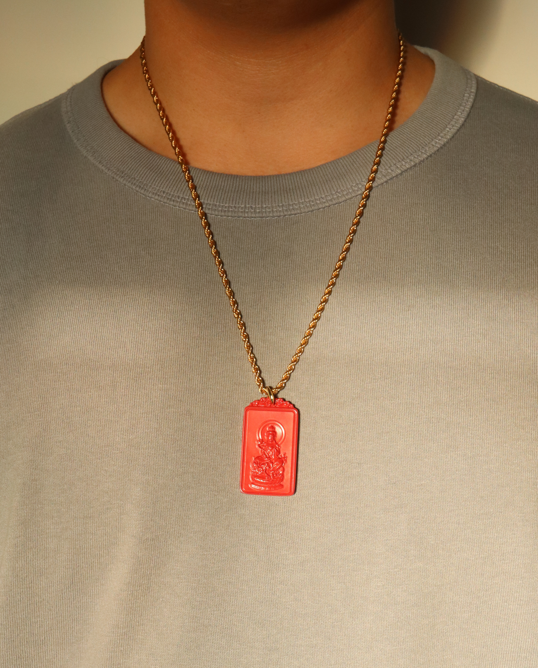 Model wearing the zodiac cinnabar pendant necklace in Large on the gold chain