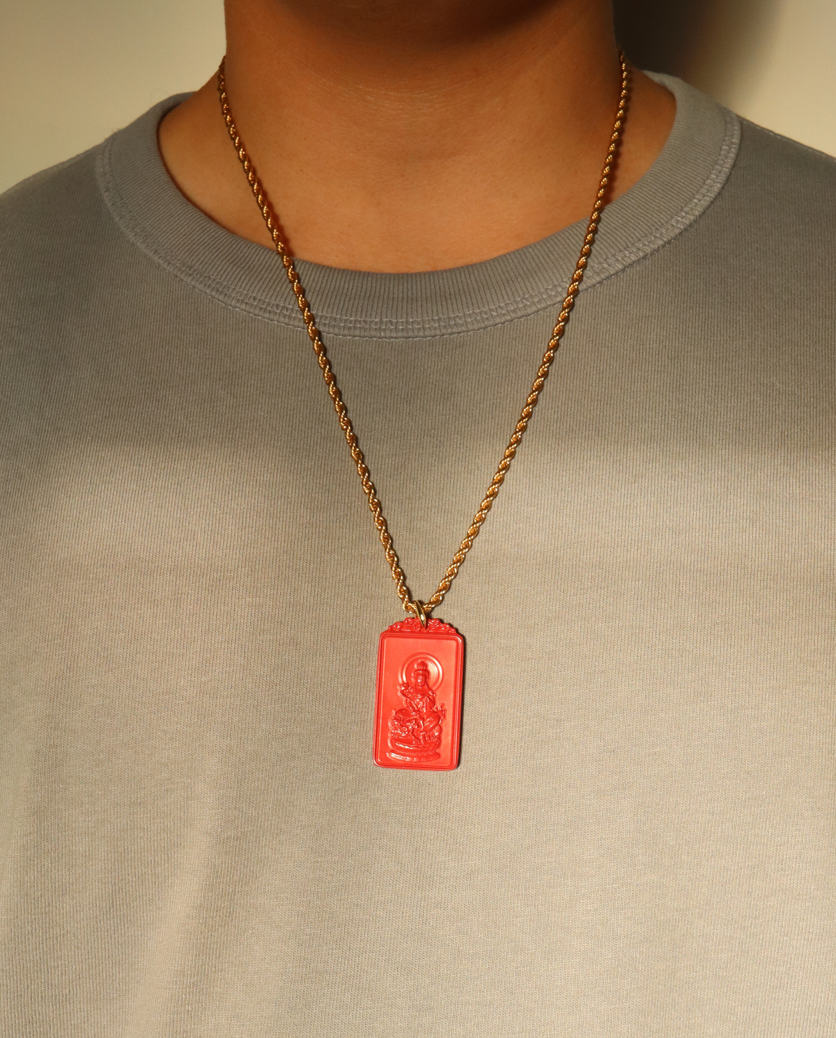 Model wearing the zodiac cinnabar pendant necklace in Large on the gold chain
